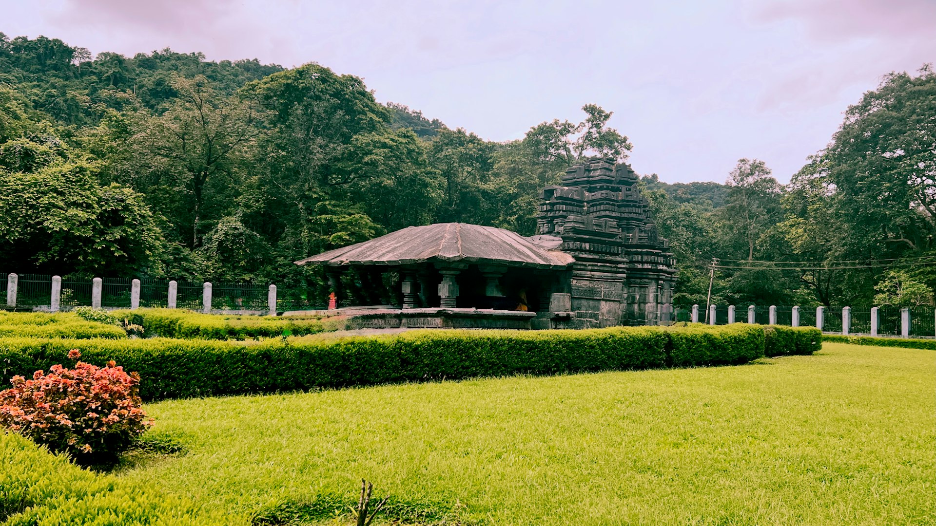 A gazebo in the middle of a lush green field